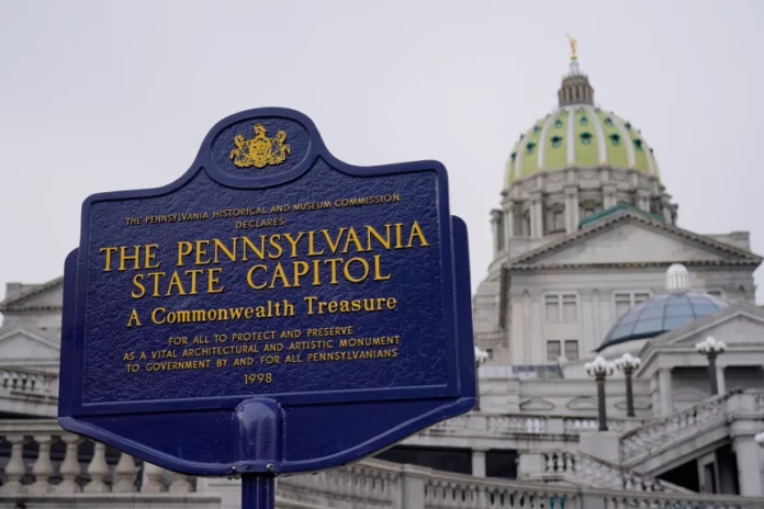FILE - An historical marker at the Pennsylvania Capitol in Harrisburg, Pa., is seen on Feb. 21, 2023. A partisan dispute about funding for three of Pennsylvania’s state-related universities may mean higher tuition for in-state students as a budget impasse continues further into the summer. The state government approached two weeks without full spending authority on Tuesday, July 11, while loose ends remained untied. (AP Photo/Matt Rourke, File)
