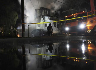 2 officers are wounded by gunfire at a suburban Philadelphia home that is then gutted by fire gunfire
