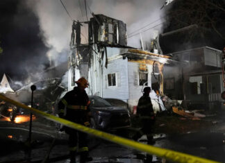 Gunshots and then a fire at a suburban Philadelphia home leave 2 officers wounded, 6 people missing fire