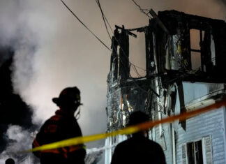 Search expected at charred home after shootout and fire left 2 officers hurt and 6 people missing fire