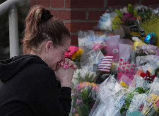 Prosecutor says officer killed in gunman’s Pennsylvania hospital siege was hit by police fire officer